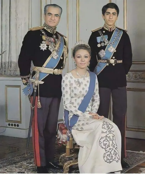 His Majesty, the Shah of Iran and youth in military uniforms stand beside a seated woman wearing a tiara and white gown — a public domain photograph from The Shah of Iran archive documenting the Pahlavi era.